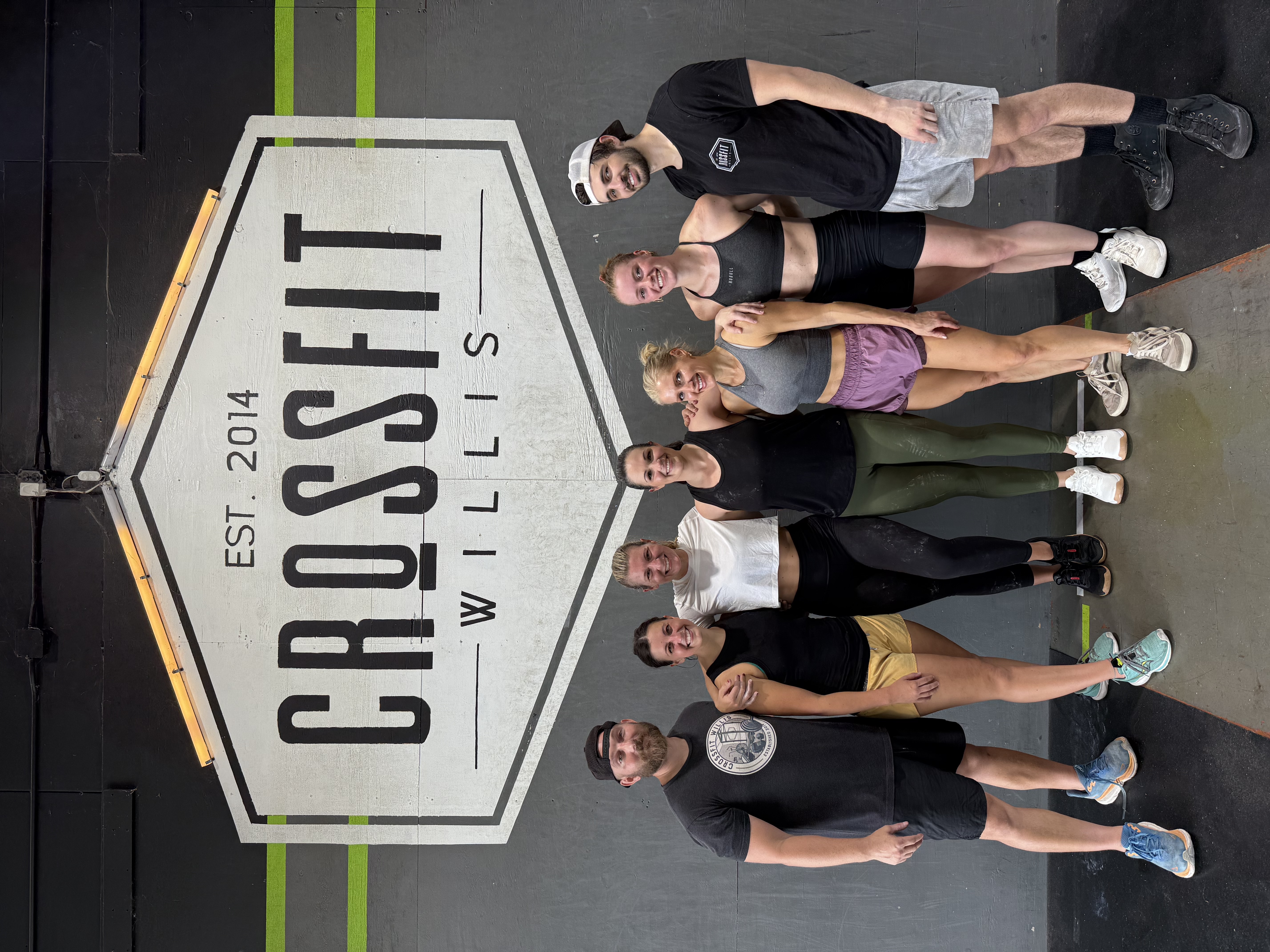 CrossFit Willis crew in front of the gym sign